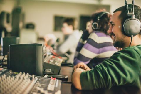 Producer Directing a Voice Over session at a sound board