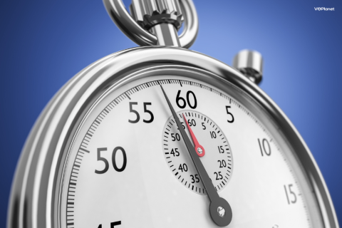 A close up of the top half of a silver analog stopwatch on a blue background