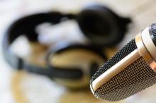 Voice Over Microphone and Headphones Voice over mic with out of focus headphones in background