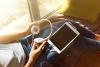 Voice actor holding headphone with tablet Voice actor holding headphones with tablet on lap
