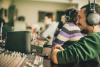 How to Direct a Professional Voice Over Session Producer Directing a Voice Over session at a sound board