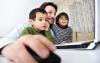 Fifteen Years of Working and Schooling From Home man working on laptop with two children