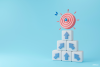 How to Book More Voice Over Jobs blue arrows on white cubes pointing up towards a red target with a blue arrow in the bullseye