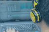 Should I Compress My Voice Over? Looking over the should of someone wearing headphones at a computer screen with editing software open